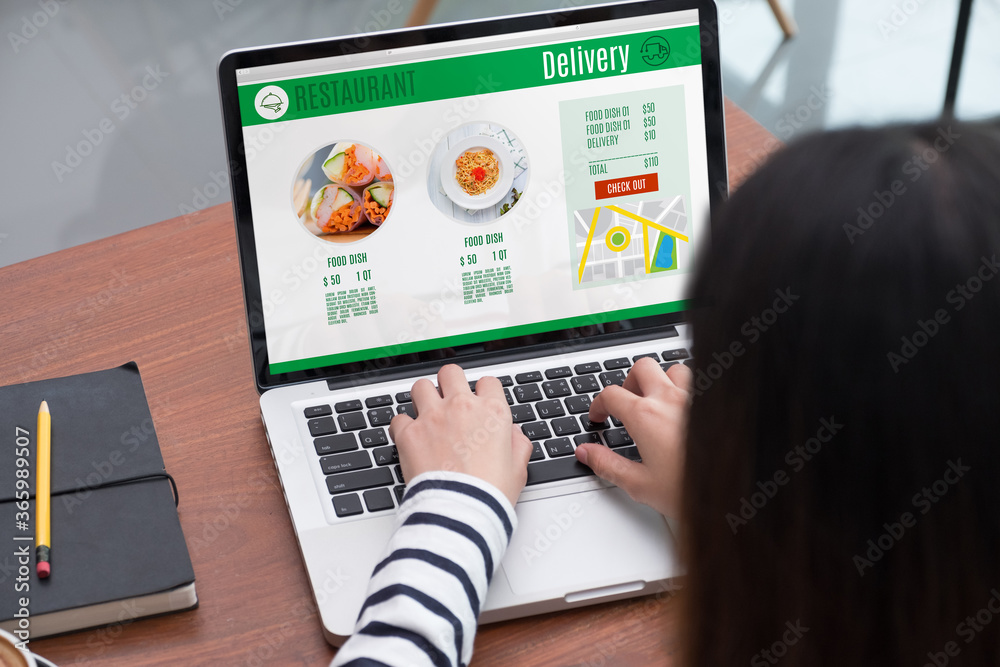 Aufkleber close up woman sitting and orde food online on laptop computer in add to cart function webpage at co