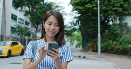 Woman use of smart phone at street