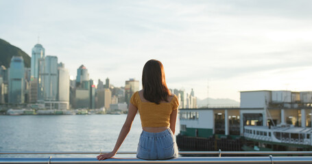 Woman look at the city view in sunset time