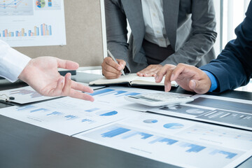 Three business leaders talk about charts, financial graphs showing results are analyzing and calculating planning strategies, business success building processes
