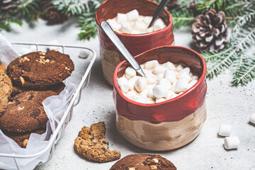 Christmas background. Winter cocoa with cookies in Christmas decoration on gray background.
