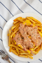 Homemade Animal Style French Fries on a white plate, top view. Flat lay, overhead, from above.