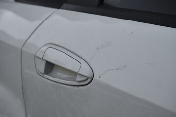Obraz na płótnie Canvas Dirty, stained door handle of white car