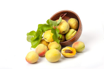 Fresh ripe apricots in wooden bowl isolated on a white background.