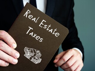 Financial concept meaning Real Estate Taxes with phrase on the piece of paper.