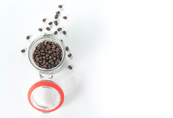 glass bottle with coffee beans isolated on white background.