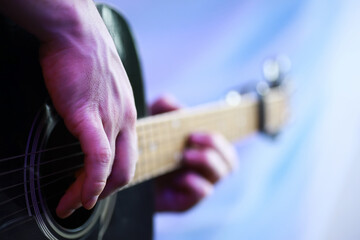 An acoustic guitar for an artist playing a stringed musical instrument on stage. Black guitar with...