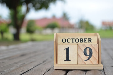 October 19, Number cube with a natural background.
