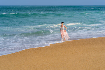 Fototapeta na wymiar Romantic young girl running on the waves. Beautiful model. Soft background