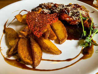 chicken with sauce and baked potatoes