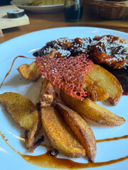 chicken with sauce and baked potatoes