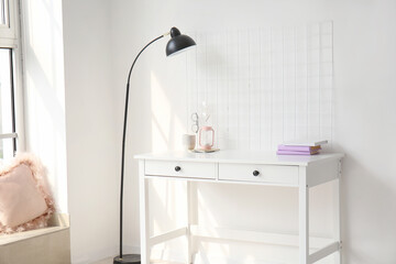 Stylish workplace near white wall