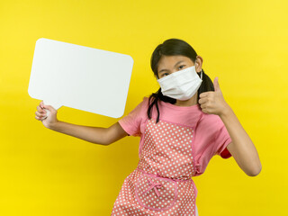 Asian girl showing blank speech bubble on yellow background.