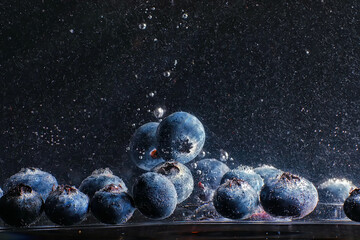 Water drops on ripe sweet blueberry. Fresh blueberries background with copy space for your text. Vegan and vegetarian concept.