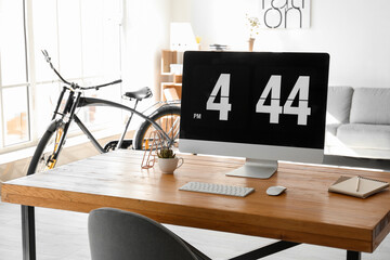 Stylish interior of room with workplace and bicycle