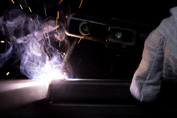 Hand arc welding metal  assembly object industrial construction welder working steel beginner practice in factory