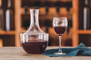 Decanter and glass of wine on table in cellar