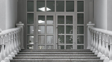 stone step of wide luxury staircase with white marble railing and glass big door front view of...