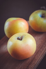 Apples on wooden cutting board