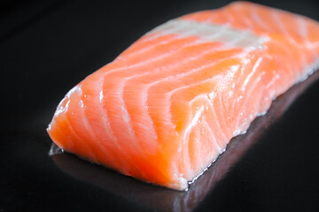 Salmon steak isolated on black background