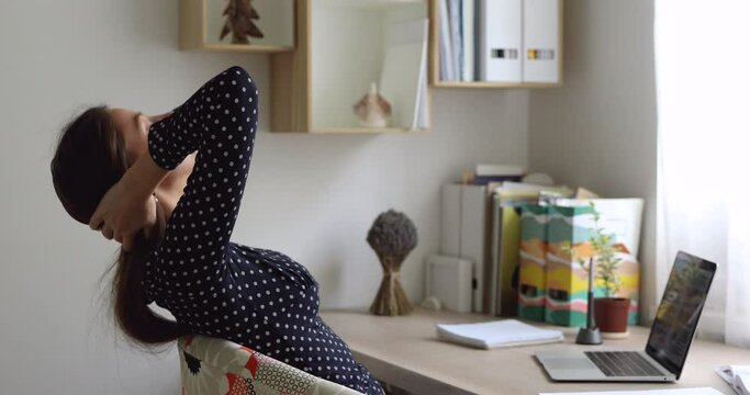 Girl sit at table use pc finish studying accomplish essay exam preparation, freelancer ending remote job, resting leaned on comfy chair feels serene and satisfied after busy fruitful workday concept