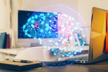 Double exposure of work space with computer and human brain drawing hologram. Brainstorm concept.