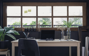 Modern home office creative space perfect for working from home lifestyle with laptop on the desk and sofa in the living room, Quarantine isolation during the Coronavirus (COVID-19) health crisis