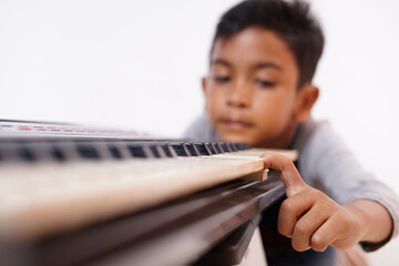 Asian little boy frustrated with playing piano