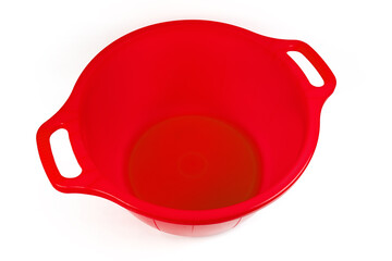 Empty red plastic household basin on a white background