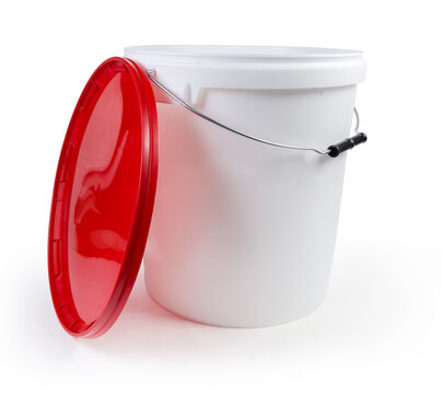 White plastic bucket with removed red lid on white background