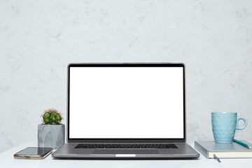open laptop with blank empty screen on white table in interior. mockup