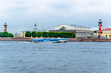 Naklejka premium The embankment of a large city, with beautiful historic buildings and sailing ships against the dark cloudy sky.