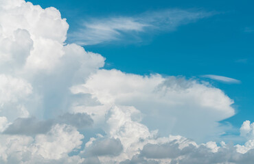 White fluffy clouds on blue sky. Soft touch feeling like cotton. White puffy clouds cape with space for text. Beauty in nature. Close-up white cumulus clouds texture background. Sky on sunny day.