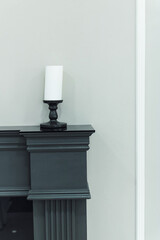 not lit candle on a vintage fireplace