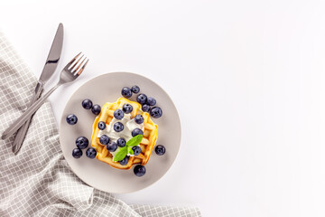 Homemade belgian waffles on served table on white background top view mockup