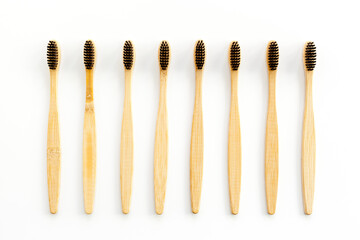 Eco materials concept with bamboo tooth brush on white background top view copy space
