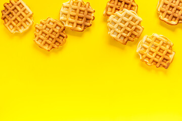Traditional belgian waffles on yellow background top view mockup
