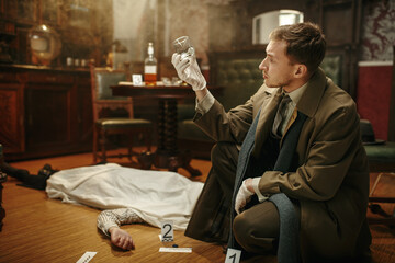 Male detective looking evidence at the crime scene