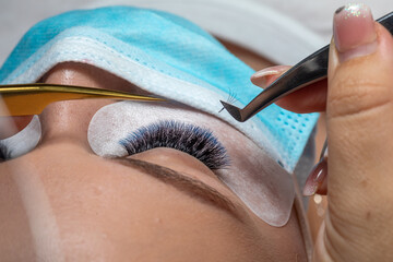Treatment of Eyelash Extension in blue color with facemask face mask