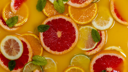 Orange juice punch with sour fruits slices