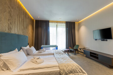 Interior of a hotel bedroom with baby cot