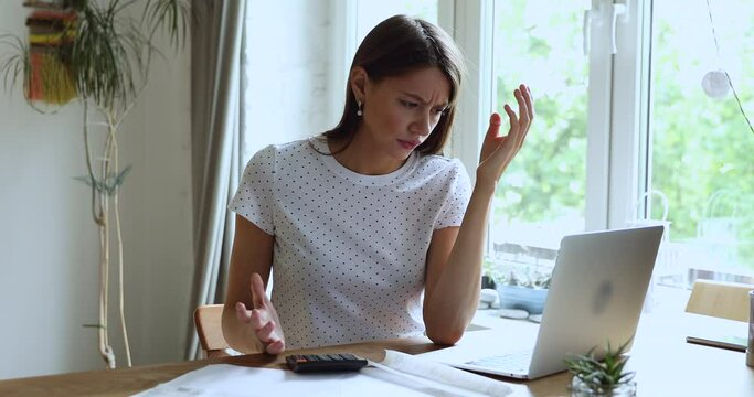 Young woman sitting at desk do finance analysis, check bills feels stressed and worried due lack of money, small business entrepreneur bankruptcy financial problems, overspend and bank debt concept