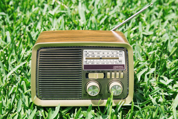 Vintage radio on a green grass background
