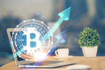 Multi exposure of blockchain theme hologram and table with computer background. Concept of bitcoin...
