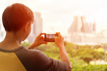 Obraz na płótnie Canvas Tourist man taking photo in with smartphone