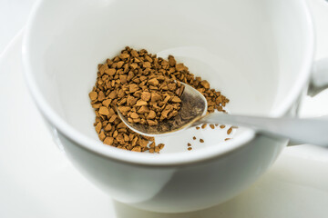 dry crumbly coffee at the bottom of a white Cup