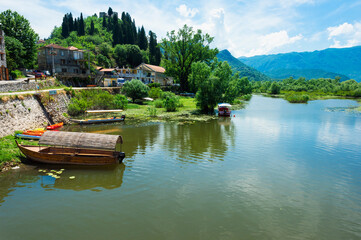 Tourist boat anchored near a Roman bridge, Skadar Lake, Virpazar, Montenegro