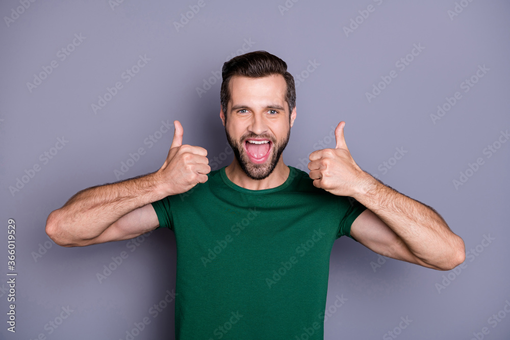 Sticker Photo of attractive handsome guy raise thumb fingers up overjoyed open mouth expressing agreement approval wear casual green t-shirt isolated grey color background