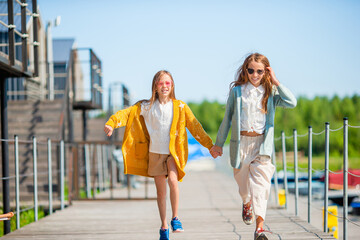 Adorable little girls in port on vacation