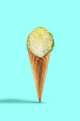 Half a raw cabbage in a wafer cone against turquoise background. Healthy nutrition, seasonal vegetables harvest. Close up, copy space